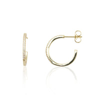 Gold hoop earrings on a white background