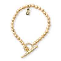 Gold beaded bracelet with a gold clasp on a white background