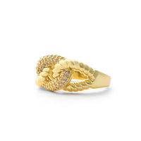 Gold ring with intricate design on a white background