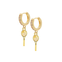 Gold hoop earrings with key charms on a white background