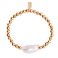 Gold beaded bracelet with a large white pearl on a white background