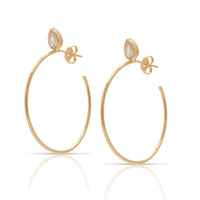 A pair of 18kt gold-plated hoop earrings with genuine CZ accents.