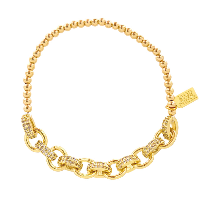 Gold bracelet with chain and beaded design on a white background