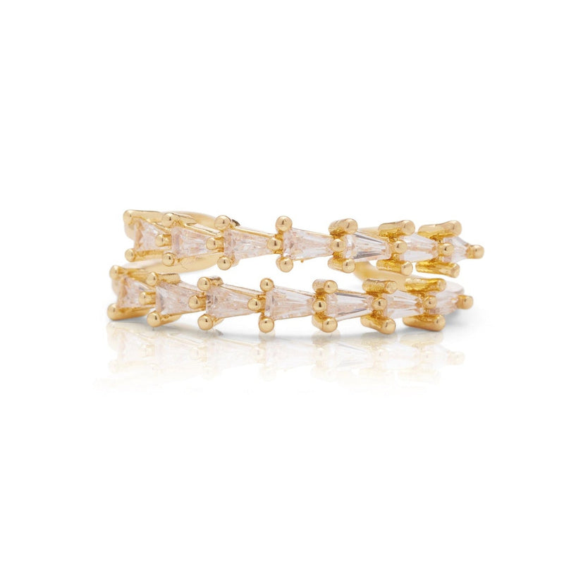 Gold and clear gemstone ring on a white background