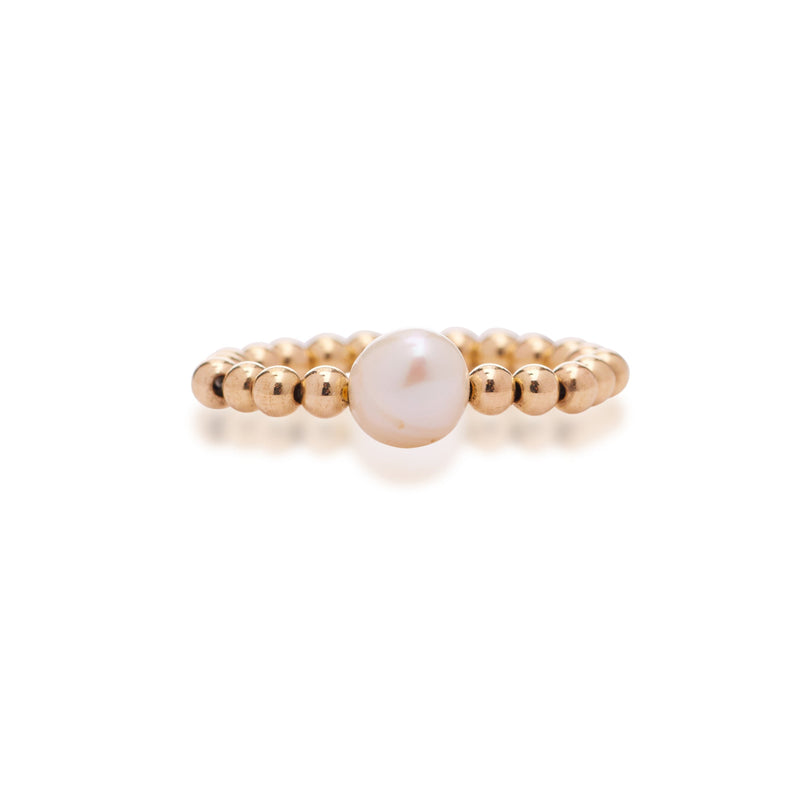 A gold-filled ring with a single pearl accent, featuring a stretchable band.