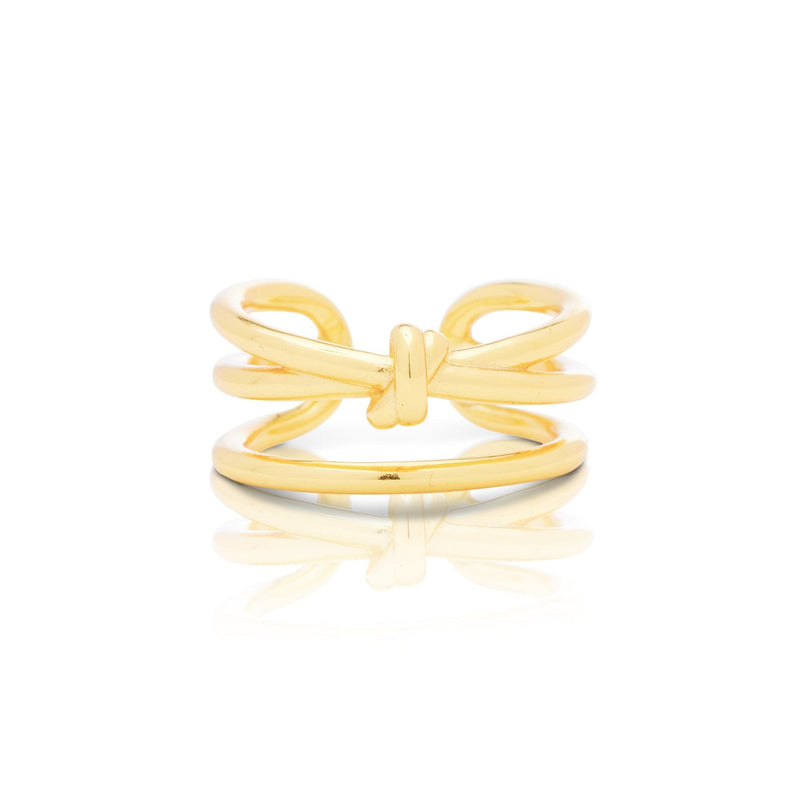 Gold bow-shaped ring on a white background