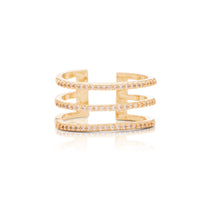 A gold-plated adjustable ring with multiple bands and clear cubic zirconia accents